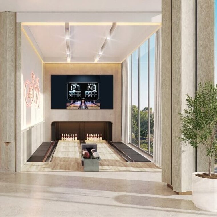 Private bowling alley at Al Yalayis by Ellington — two lanes with a lit scoreboard and fluted timber walls