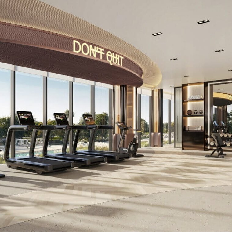 Fitness studio at Al Yalayis by Ellington — a row of treadmills facing full-height windows onto the landscaped grounds