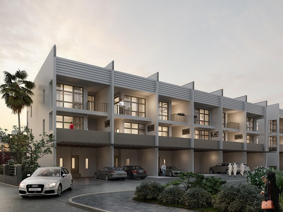 Townhouses at Al Yalayis by Ellington — a row of three-storey townhouses at dusk with recessed balconies, louvred screening and covered parking